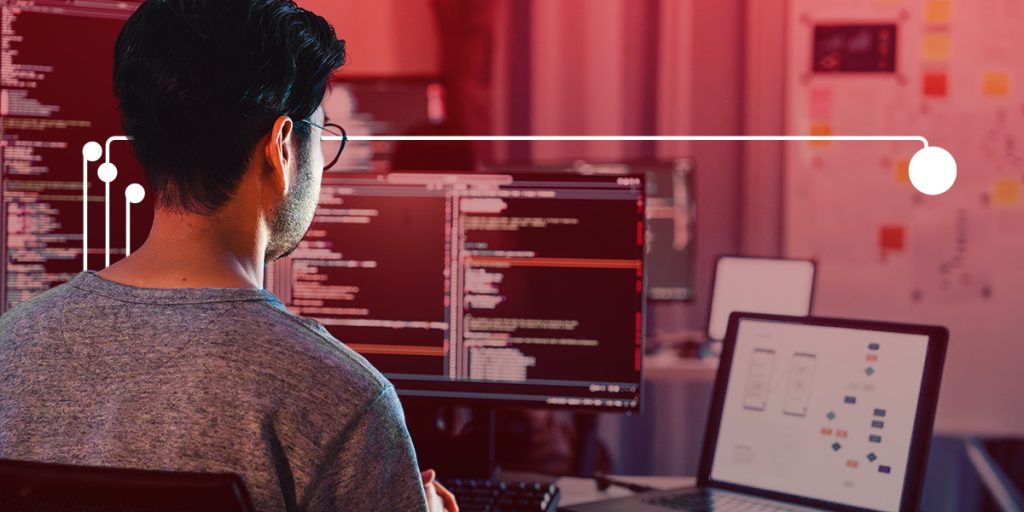 Man working on a computer on embedded software development